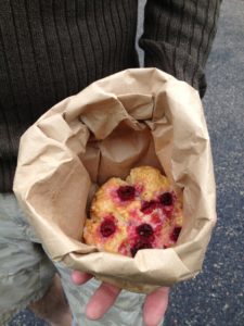 Raspberry scone in paper bag held in man's hand on Ice Age Trail near Waupaca River.