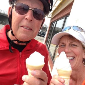 Man and woman eating ice cream cones.
