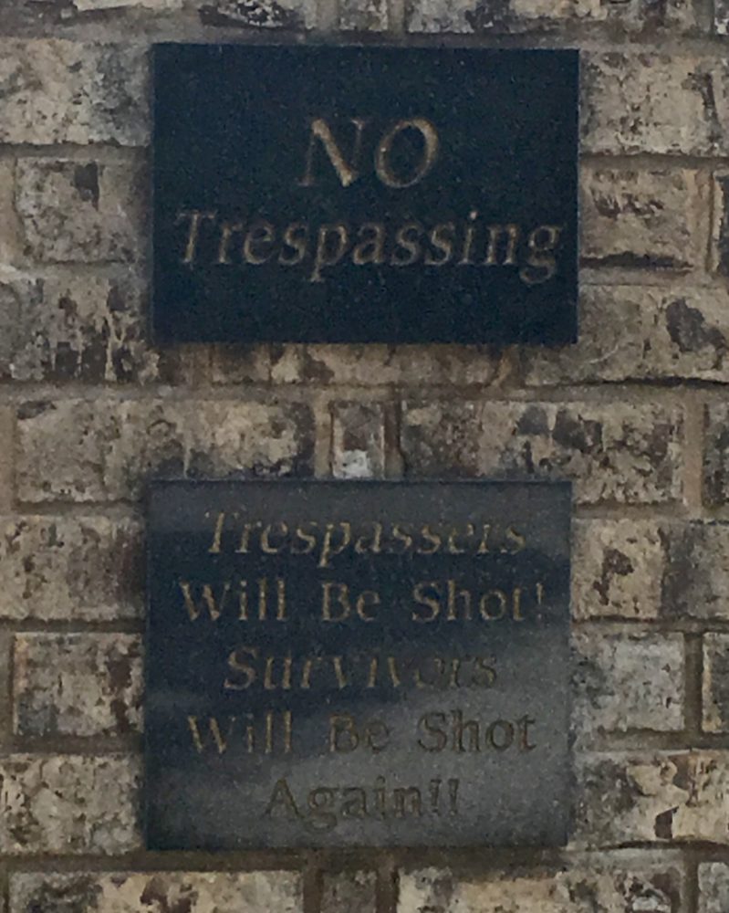 No trespassing sign proclaiming violators will be shot and shot again.