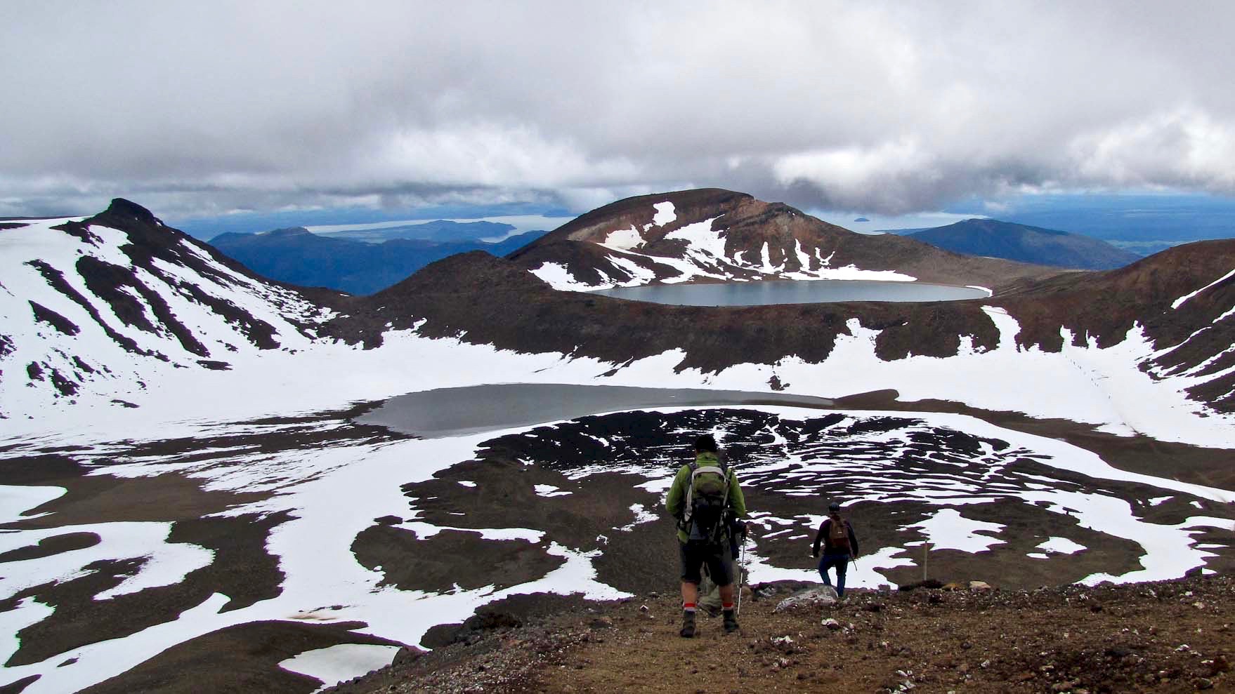 View of hikers on snow-covered volcano in New Zealand, taken by The Thousand-Miler