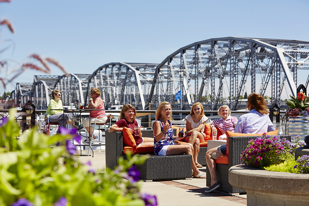 People sitting by Sturgeon Bay's canal, eating and talking.