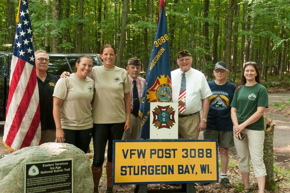Veteran hikers, part of Warrior Expeditions program, pose with members of a VFW post.