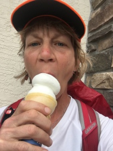 Female backpacker eating a vanilla ice cream cone near Platts Bluff in Florida.