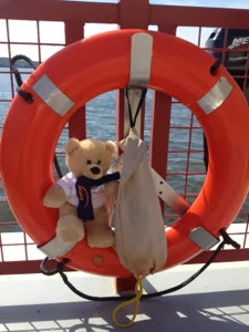 Teddy bear in orange life ring on ferry near Lodi.