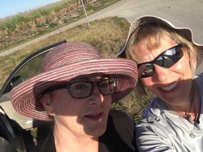 Two women with sunglasses and hats taking a selfie in Florida.
