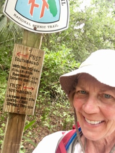 Woman hiker by a Florida Trail sign.