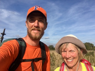 Male and female backpackers taking a selfie.