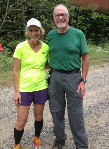 Older man in green shirt posing with woman in yellow shirt on the Ice Age Trail near Newwood.