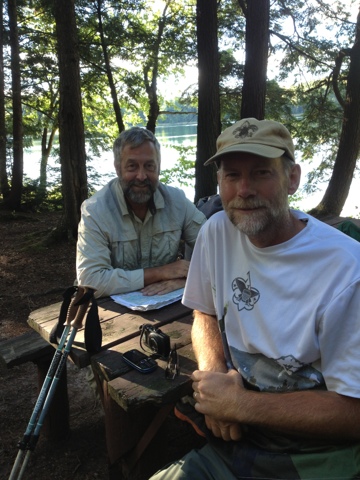 Two men sitting at a picnic table in the woods near the Highland Lakes West segment of the Ice Age Trail.