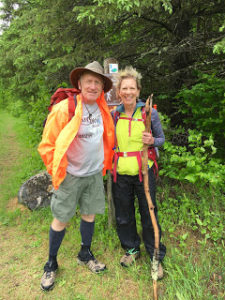 Two hikers pose before a trailhead in Jay Cooke State Park.
