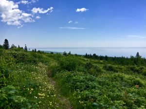 View of Lake Superior from the top of a meadow-covered bluff on the Superior Hiking Trail, where another adventure begins.