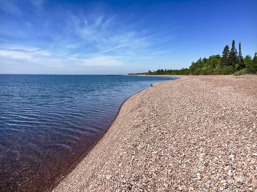 View of Lake Superior shoreline, with a rocky beach, along the Superior Hiking Trail.