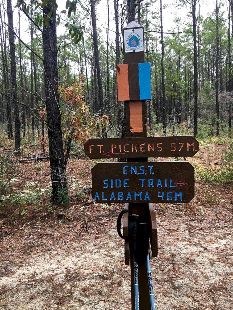 Florida Trail sign indicating directions to Alabama or Ft. Pickens in the Yellow River area.