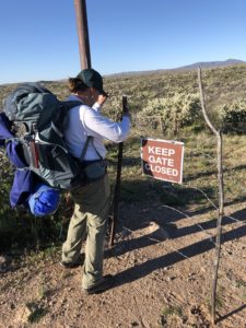 Hiker going through gate on Arizona Trail near Freeman Road.
