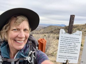 Woman standing at southern terminus of Arizona Trail.