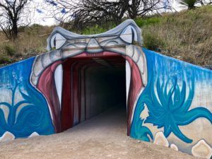 Tunnel on the Arizona Trail painted like a rattlesnake's mouth.