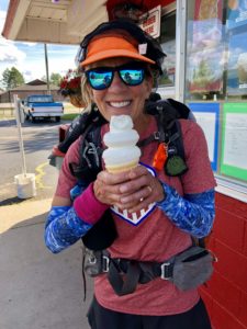 Female backpacker holding vanilla ice cream cone in Solon Springs, Wis.