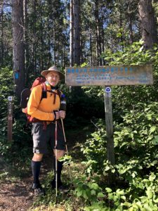 Male backpacker by North Country Trail signpost heading toward Solon Springs, Wis.