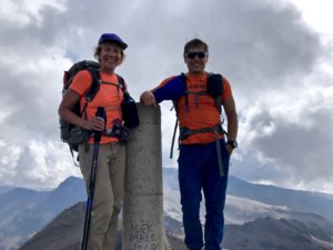 Male and female backpackers on the top of a mountain in Spain's Sierra Nevada