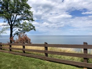 View of Lake Superior fronted by brown fence near Wisconsin-Michigan border.