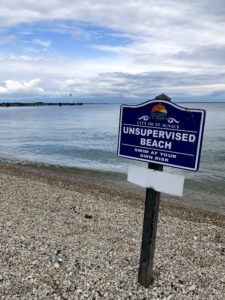 Sign on beach in St. Ignace warning there are no lifeguards and you swim at your own risk.
