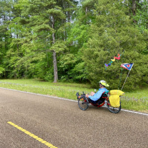 Man on a recumbent cycle, peddling on the Natchez Trace.