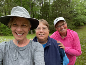 Three women pose for a photo on the Natchez Trace near French Camp.