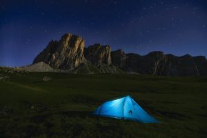 Tent set up in the wilderness, at night.