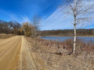 Road passing lake near Hickory Corners