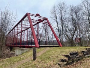 Red iron bridge in a park