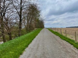 Crushed limestone path in between farm fields and an old canal,