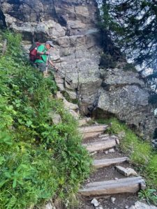 Man hiking down steep steps in the mountains.