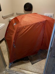 Orange tent in a bathroom.