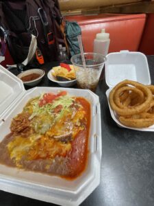 Enchiladas, onion rings and chips.